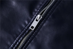 Macro detail of high-quality PU leather texture and silver metal zipper on men's jacket