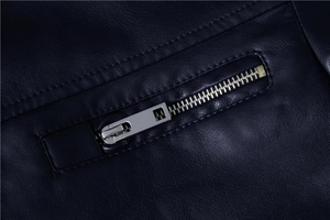 Macro detail of dark blue faux leather jacket featuring silver metal zipper and stitching