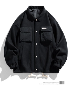 Detail of black waffle texture jacket with white buttons and drawstring hem for men