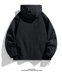 Rear view of black hooded windbreaker with adjustable hem drawstrings and textured fabric