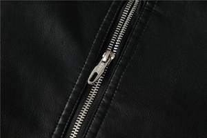 Detailed macro view of the silver metal zipper on the black PU motorcycle jacket