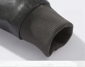 Detailed macro view of the men's PU jacket showing ribbed knit cuffs and leather texture