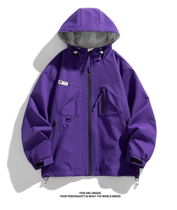 Detail of purple hooded windbreaker showing zipper pockets and adjustable velcro cuffs
