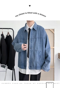 Detailed view of light blue vintage denim jacket with metal buttons and classic wash texture