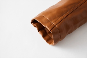 Detailed close-up of brown PU leather jacket cuff with professional double stitching