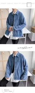Detail view of oversized light blue denim jacket with classic buttons and chest seams