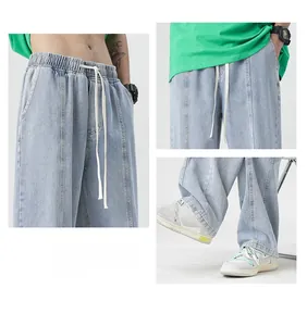 Detailed macro view of elastic drawstring waist and loose fit on light blue washed denim jeans