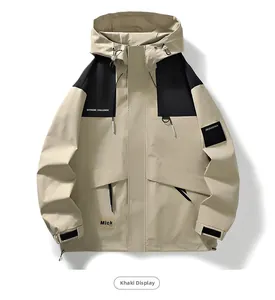 Detail of khaki outdoor jacket showing black shoulder panels and chest text labels