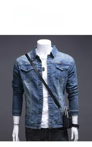 Detail of mid-blue denim jacket featuring classic workwear pockets and washed texture