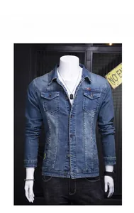 Detail of classic blue slim fit denim jacket with chest pockets and copper buttons