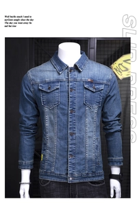 Detailed view of casual blue denim jacket featuring metal buttons and faded vintage texture