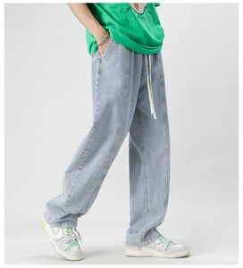 Detail of light blue wide-leg jeans featuring elastic waistband and white drawstring