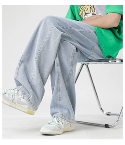 Detailed view of light blue washed wide-leg denim jeans with high-quality drape and stitching