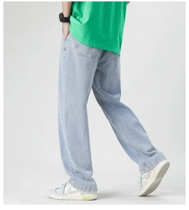Detail view of light blue straight jeans showing denim texture and classic back pocket