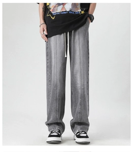 Detail view of dark grey wide-leg jeans featuring vertical stitching and a drawstring waist