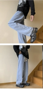 Detailed view of light blue wide-leg denim jeans with drawstring waist and loose fit design