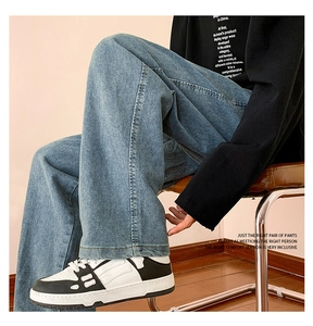 Detail view of light blue wide-leg jeans with classic wash finish and double-stitched hem