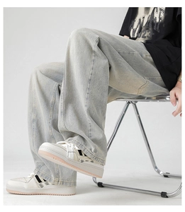 Detail of light blue wide-leg jeans showing the denim texture and loose drape on model