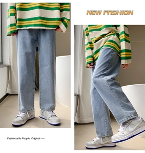 Detail view showing light blue washed denim straight leg jeans and striped long sleeve top