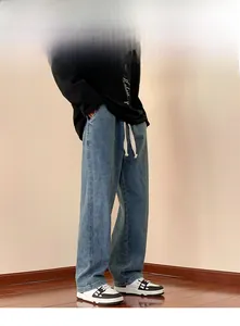 Detailed view of men's wide-leg vintage light blue jeans with white drawstring waist