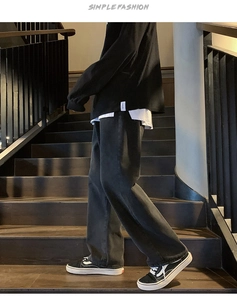 Détail du jean vintage délavé noir pour homme avec une coupe droite et des jambes larges
