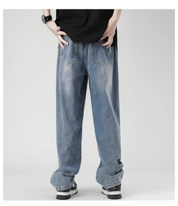 Detail view of back pockets and washed texture on light blue wide leg jeans