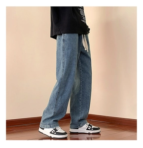 Close-up of vintage washed blue wide-leg jeans with adjustable white drawstring waist