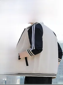 Detail of hooded baseball jacket showing elastic striped cuffs and contrast sleeves