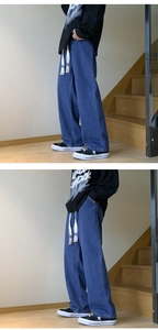 Detailed view of blue wide-leg jeans with white drawstring and high-quality denim texture