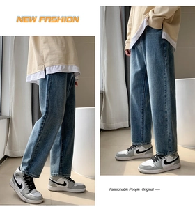 Detail showing the straight leg cut and medium blue wash of these relaxed fit denim jeans