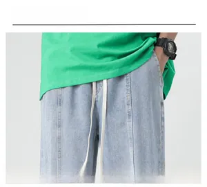 Detail view of men's light blue denim jeans with elastic drawstring waist and side pockets