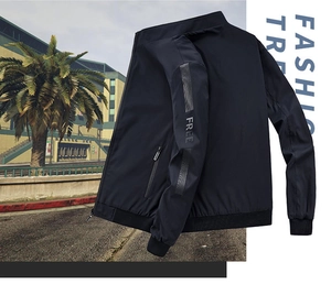 Detail of navy blue reversible jacket featuring standing collar and FREE sleeve print