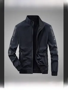 Detail of dark blue reversible jacket featuring ribbed cuffs and FREE letter pattern print