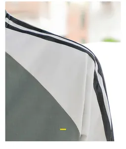 Detail of multi-color baseball jacket featuring black shoulder stripes and premium fabric