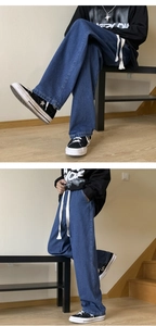 Detail of mid-blue wide-leg jeans with white drawstring waist and loose straight cut