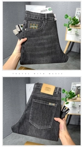 Détail de jean homme gris foncé avec étiquette de taille en cuir et bordure de poche