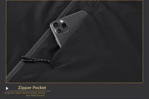Detail of a secure side-zip pocket on a black jacket with a phone for size scale