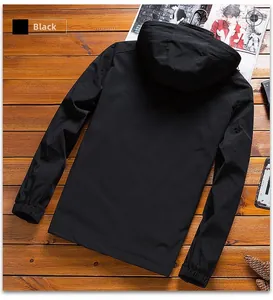 Flat lay of a black hooded business casual jacket on a wooden background with magazines