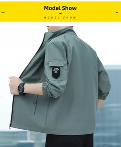 Detail of the tactical sleeve pocket and woven patch on this green outdoor jacket