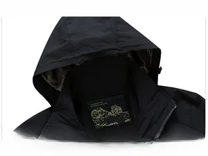 Detail of men's hooded windbreaker featuring stand collar with breathable mesh lining