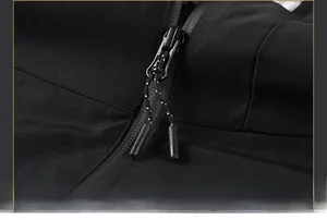 Detail of waterproof zipper and textured pull cord on black slim-fit casual jacket