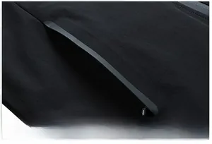 Close-up of side zipper pocket and texture on men's black business casual jacket