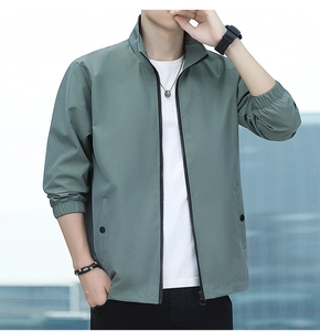 Detail of grey-green men's casual jacket featuring metal zipper and button pockets