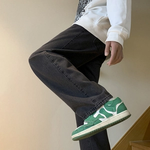 Men's vintage black washed straight leg loose denim jeans styled with casual sneakers