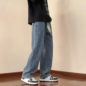 Men's vintage wide leg denim jeans in washed blue with white drawstring waist