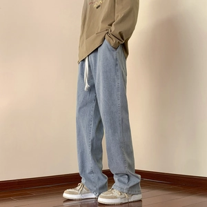Men's loose straight leg jeans in light blue wash with casual white waist drawstring