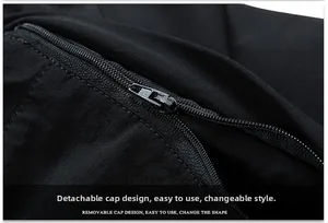 Detail view of the functional removable hood design with a smooth zipper on a black jacket