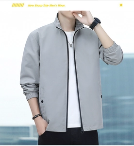 Detail of light gray men's jacket showing zipper, stand collar, and snap pocket buttons