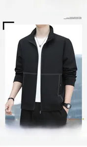 Detail of black casual jacket featuring white double stitching and ribbed cuffs