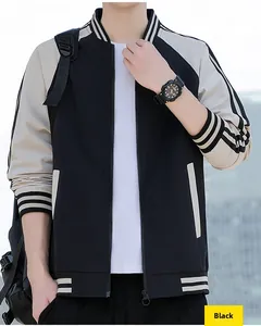 Detail of black and cream varsity jacket with striped ribbed cuffs and zipper closure